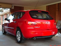 Shiny Red Mazda rear view